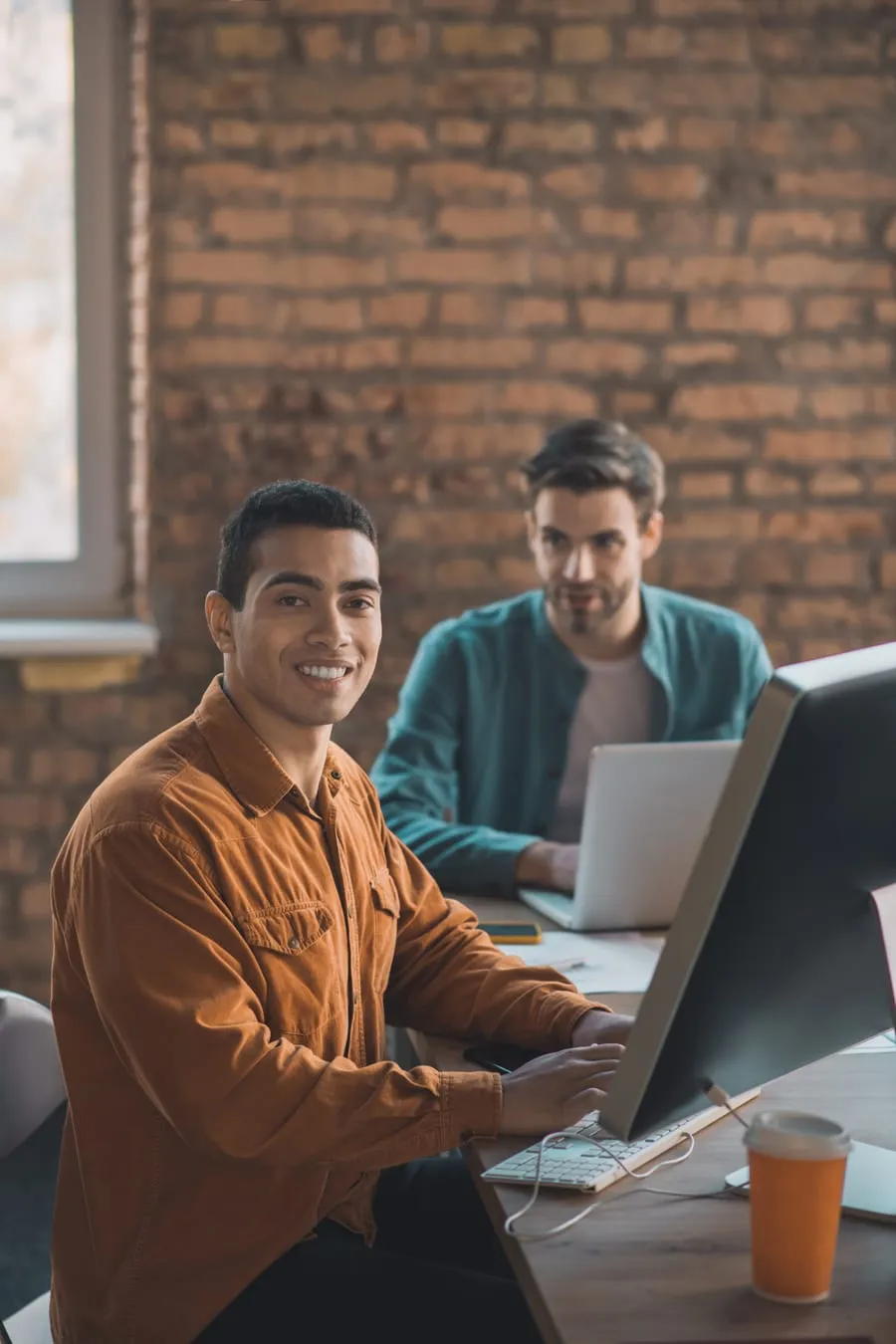 Two Develi engineers working side by side at a studio desk