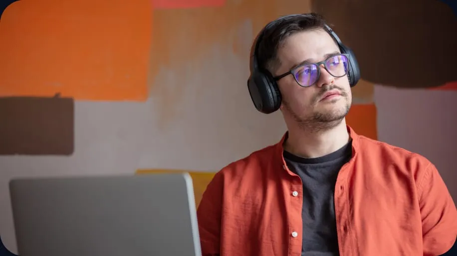 A Develi engineer working at a desk in the studio